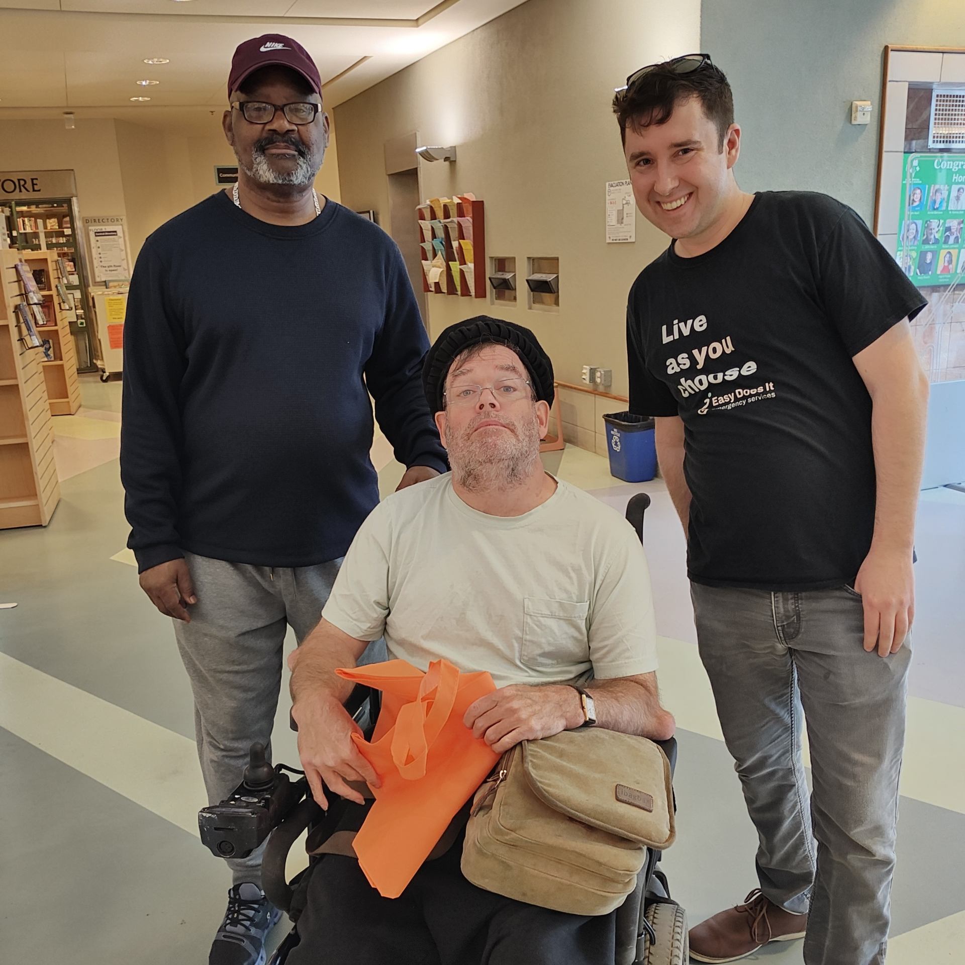 Our Team poses for a photo with a client at our Library Repair Workshop.