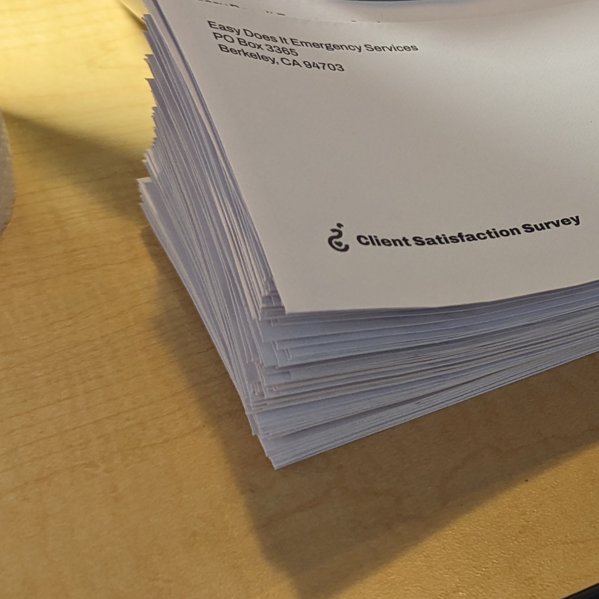 A photo of an envelope with our logomark and the words Client Satisfaction Survey printed on it.